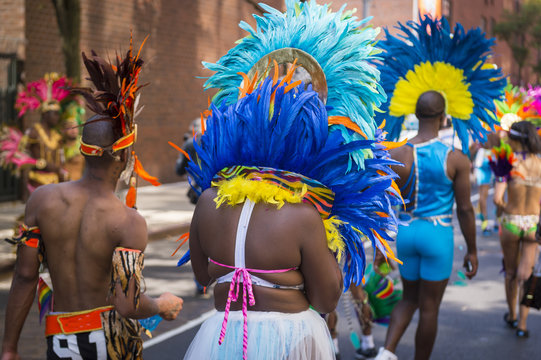 Unrecognizable group of dancers wearing colorful feathers costumes gathered for a carnival parade