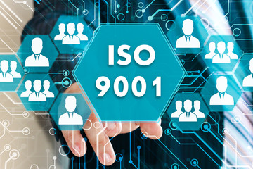 The businessman clicks the  button ISO 9001 on the touch screen