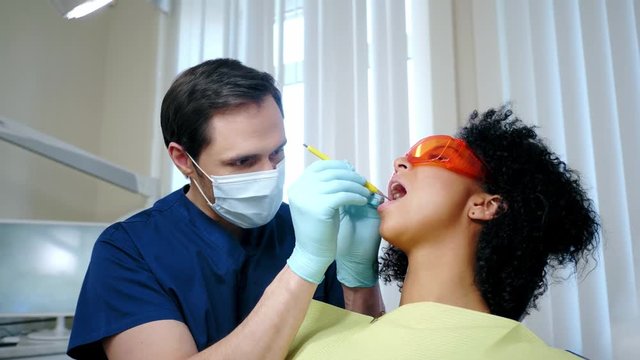 Dentist and his assitant working in private practice.