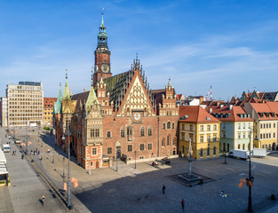 Old Gothic city hall in Wroclaw (Breslau) in Poland, built in 14th century and historic market square (Rynek). Aerial view. Early morning
