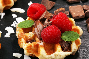 Belgian waffles with pomegranate and raspberries, homemade healthy breakfast with mint