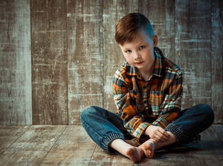 little boy in colorful shirt portrait on wooden background