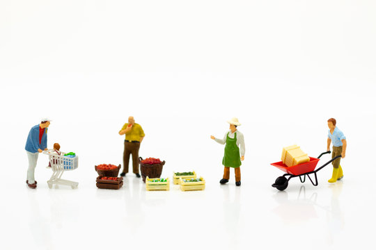 Miniature people : Spending cash for shopping in the market. Image use for marketing, merchant middleman,retail business concept.