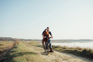 couple in love on a bike on nature in autumn