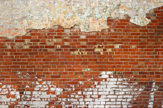 Empty Old Brick Wall Texture. Painted Distressed Wall Surface. Grunge Red Stonewall Background. Shabby Building Facade With Damaged Plaster. Copyspace.