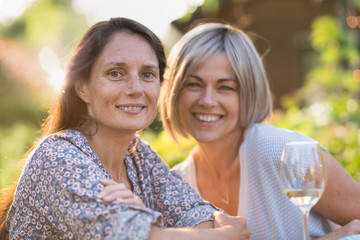  Portrait of two beautiful women in their forties. moment of complicity for female friends posing...