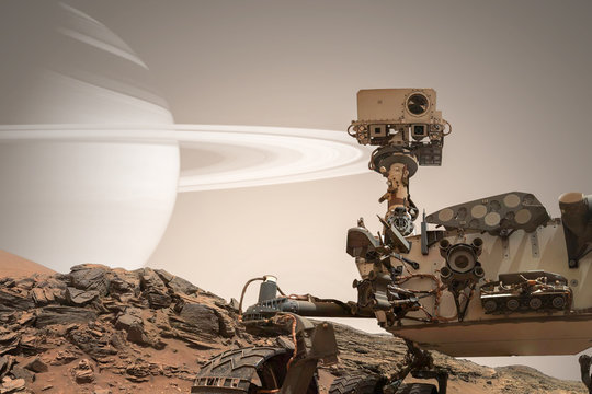 Curiosity Mars Rover exploring the surface of red planet. Elements of this image furnished by NASA.