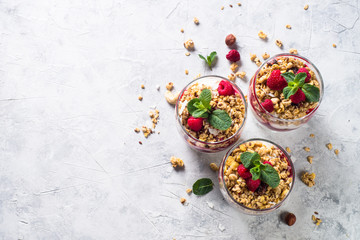 Fototapeta na wymiar Yogurt parfafait with granola and raspberries top view.