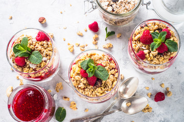 Yogurt parfafait with granola and raspberries top view.