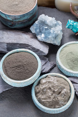 Obraz na płótnie Canvas Ancient nature minerals, different types of clay used for skincare, spa treatments, face masks, gray, black, green and blue mud, close up