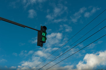 Green Traffic Light with Timer and Pedestrian Crosswalk Stop Signal on Blue Sky Empty Background....