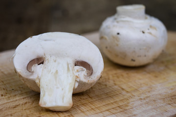 Tasty mushrooms on a wooden table. Mushrooms in the kitchen on a chopping board.