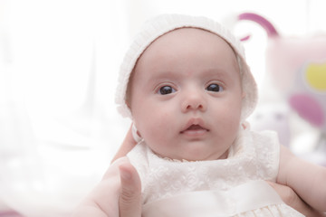 baby with white dress and hat