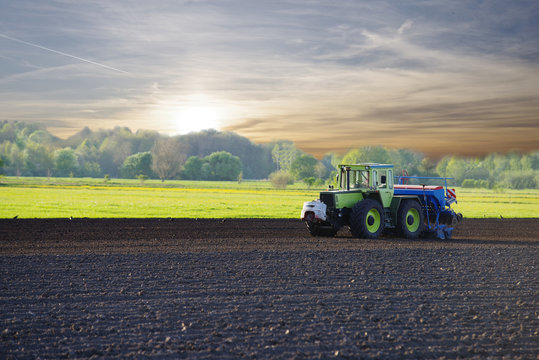 Traktor auf einem Feld im Sonnenuntergang 