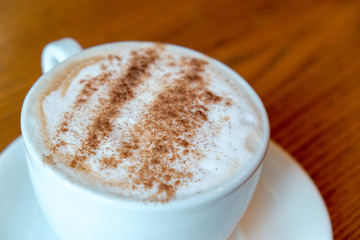 Close-up coffee in white  cup on wooden background. Top view