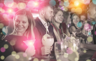 Obraz na płótnie Canvas Girl with friends partying in bar