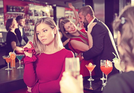 Girl upset because boyfriend flirting with other woman in bar