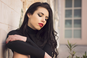 close up portrait of beauty brunette girl dressed in black in street