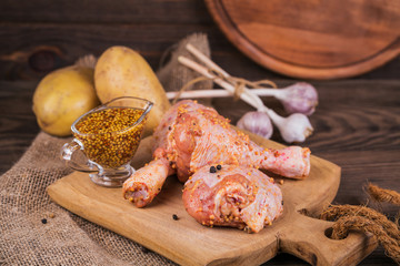 Marinated chicken legs with raw potatoes and garlic