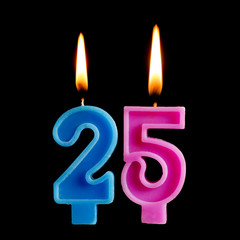 Burning birthday candles in the form of 25 twenty five figures for cake isolated on black background. The concept of celebrating a birthday, anniversary, important date, holiday