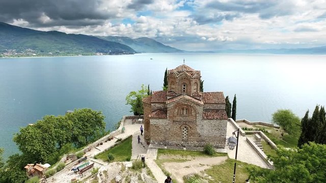 Church of Saint John at Kaneo and Ohrid lake with dramatic sky. cinematic steadicam shot