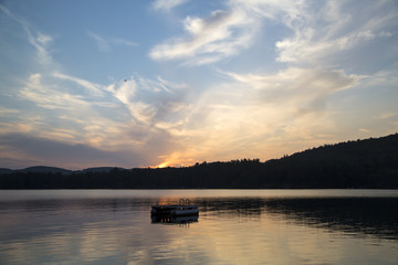 Fototapeta na wymiar Metal swim platform, Squam Lake, New Hampshire, at sunset