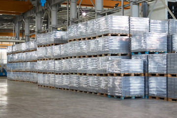 Large Warehouse interior with goods on pallet inside a Factory building. Industry manufacturing concept