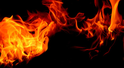 Fototapeta premium Closeup of fire flame and wood burning in fireplace.