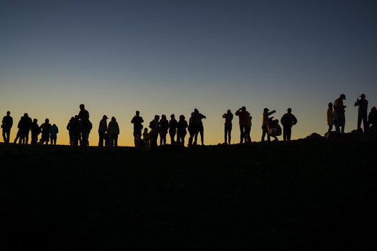 silhouette of photographers waiting for the sun to set