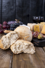 Fresh baked bread. Different snack for wine. Cheese and olives