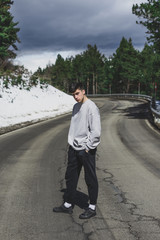 Young boy in the middle of a mountain road