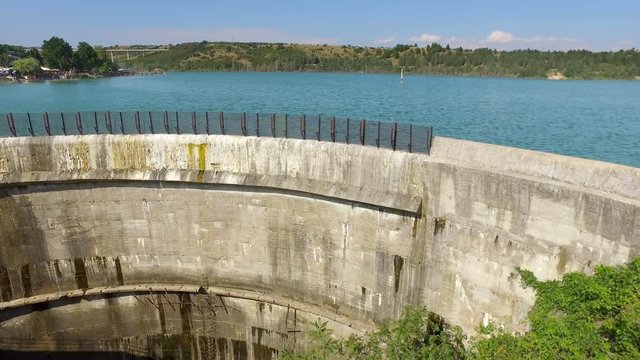 Dam wall with blue water of the reservoir