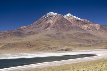 miniques volcano with snow and miscanti lagoon at andes mountain range