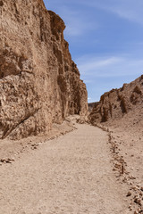 path at atacama desert surrounded by rocks leading to the moon valley