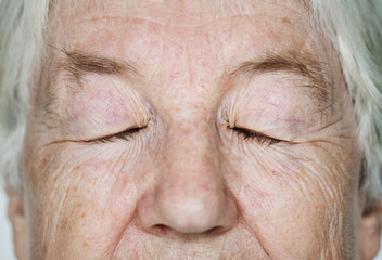Portrait of a white elderly woman eyes closed