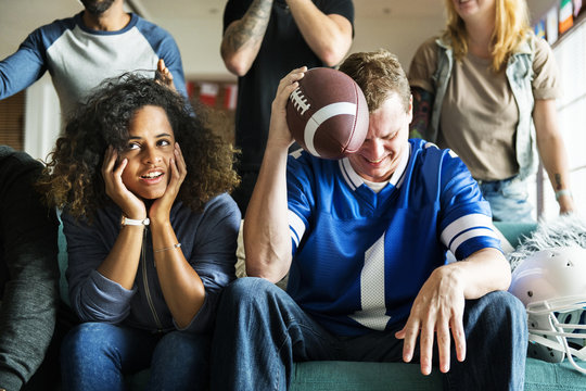 Friends cheering sport league together - Powered by Adobe