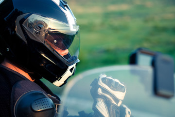 close up portrait of rider on a motorcycle - summer road trip on a motorbike