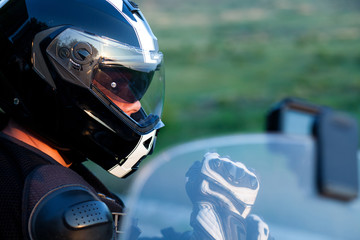 close up portrait of rider on a motorcycle - summer road trip on a motorbike