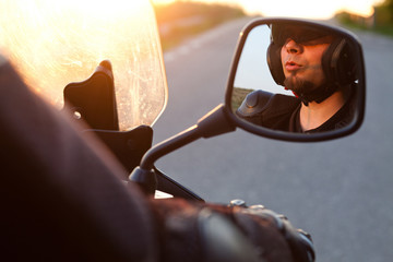 Fototapeta na wymiar close up portrait of rider on a motorcycle - summer road trip on a motorbike