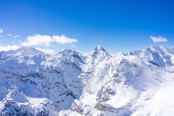 Fototapeta na wymiar Stunning panoramic view of the Swiss Alps from the top of the Schilthorn mountain in the Jungfrau region of the country