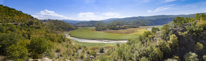 Fototapeta na wymiar Panorama of valley with river bank after water flood