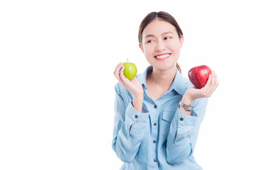 Beautiful asian woman holding apples and smiles over white background