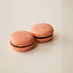 Macaroni sweets two pink on white background