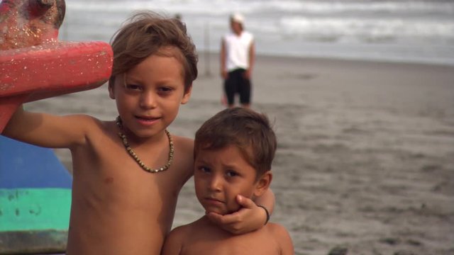 Brothers getting their picture taken on Salvadoran beach