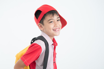 Portrait of little boy going to school with schoolbag on white background