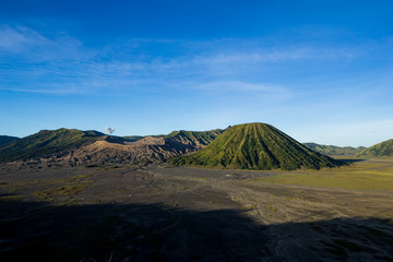 Beautiful view landscape of active volcano crater with smoke at Mt. Bromo, East Java, Indonesia.