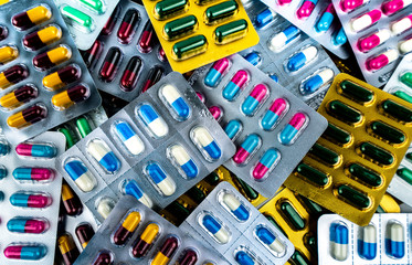 Fototapeta na wymiar Pile of antibiotic capsule pills in blister packs. Medicine for infection disease. Antibiotic drug use with reasonable. Drug resistance, healthcare concept. Pharmaceutical industry.