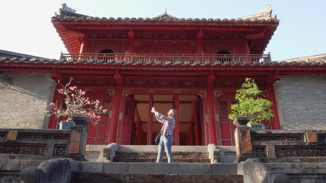 Female tourist taking pictures in the Minh Mang Tomb, Hue