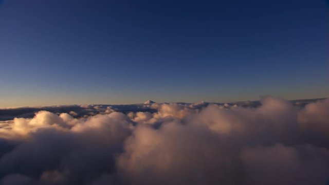Flying over lumpy clouds, tilting left