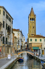 Fototapeta na wymiar VENICE, ITALY - circa MARCH, 2016: Typical Venice canal with the church of San Barnaba, with local and tourists, in Venice, Veneto, Italy